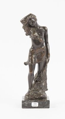 an image of a bronze statue of a woman standing on a rock