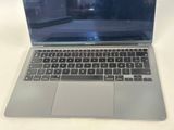 a laptop computer sitting on a table with a keyboard