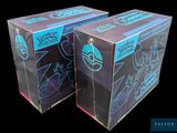two boxes of pokemon trading cards sitting on top of each other
