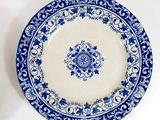 a blue and white plate with a blue flower design on it