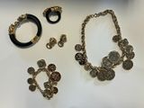 several pieces of jewelry are displayed on a white surface