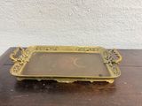 brass tray with handles and handles on a wooden table