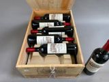 bottles of wine in a wooden box with a bottle of wine in the middle