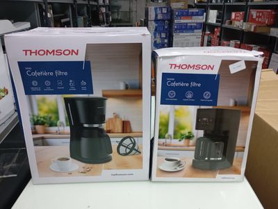 two boxes of coffee machines sitting on a table