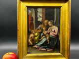 une image représentant un tableau où l'on voit une femme tenant un bébé et une pomme
