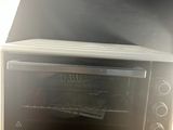 a toaster oven sitting on top of a wooden table