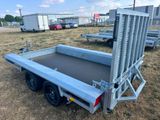 the trailer is parked in a field with other trailers in the background