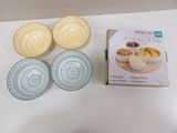 four bowls of food on a table next to a box of cereal