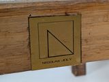 a close up of a wooden bench with a sign on it