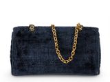 a blue velvet handbag with gold chain handles