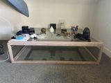 a coffee table with a glass top and a surfboard on it