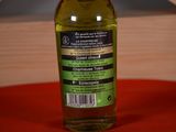a bottle of olive oil sitting on a table