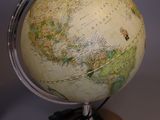 a small globe on a stand on a table