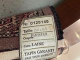 a person holding a bag that has a tag on it