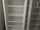 a white refrigerator with a glass door in a kitchen