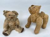two teddy bears sitting next to each other on a white surface