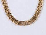 an image of a gold chain necklace on a white background