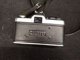 a black and silver camera with a black strap on it