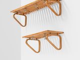 a pair of wooden shelves mounted on a wall