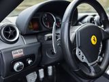 the interior of a car with a steering wheel and dashboard controls
