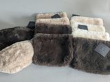 several pairs of slippers are lined up on a white surface