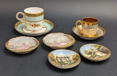 five cups and saucers with pictures on them on a table