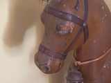 a wooden horse that is sitting on the floor