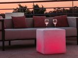 a couch and a table with a glass of wine on it