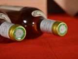 two bottles of wine sitting on a red table