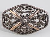 a close up of a silver and gold ring on a white surface
