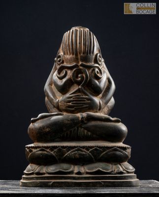 un gros plan sur la statue d'une personne assise sur une table