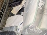 a pile of mattresses in plastic bags on the floor
