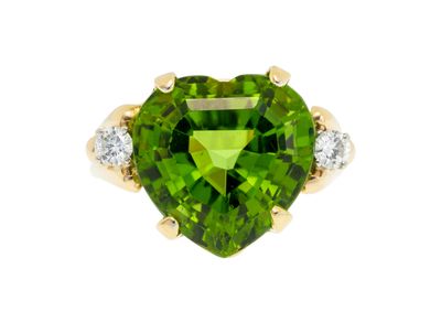 a close up of a green heart shaped ring with diamonds