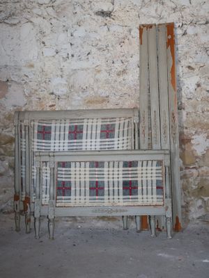 a couch and a chair in front of a stone wall