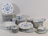 a lot of plates and cups on the table