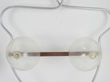 a pair of glasses hanging from a wire on a wall