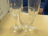 three empty wine glasses sitting on a table in front of a box