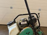 a close up of a small machine on a cart in a garage