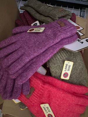 several gloves are stacked on top of each other in a cardboard box