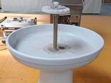 a white toilet bowl sitting on top of a wooden floor