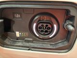a close up of a car ' s charging station with a car plugged into it