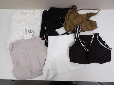 a white table with a lot of clothes on it