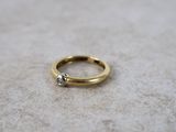a close up of a gold ring with a diamond on top of it