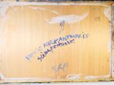a painting on the wall of a bathroom that has been vandalized