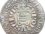 a close up of a silver coin with a design on it