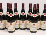 six bottles of wine are lined up in a row on a table