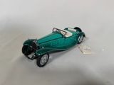 a green toy car that is sitting on a table