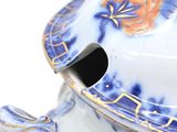 a close up of a blue and white vase with a lid