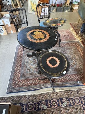 two tables and two chairs in a room with a rug