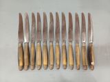 six knives are lined up next to each other on a table